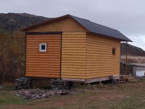 a wooden cabin on a pile of rocks at Teriberka Tour in Teriberka