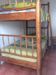 a bunk bed with a wooden bunk bed frame at Casa Canta Rana in Fronteras