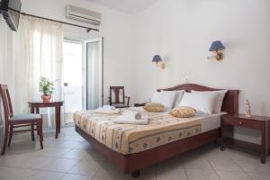 Postel nebo postele na pokoji v ubytování Hotel Meltemi
