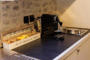 a kitchen counter with a coffee maker and a box on it at Manoir Sainte Victoire in Bayeux