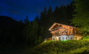 a large house on a hill at night at Mas De La Bolp - Chalet in Rabbi