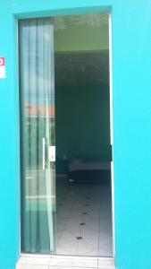 an open door to a room with a tiled floor at Apartamentos no Farol Velho in Salinópolis