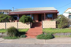 a red brick house with a red brick walkway at Bott's Beach Retreat - Maslin Beach - 100M to beach in Maslin Beach