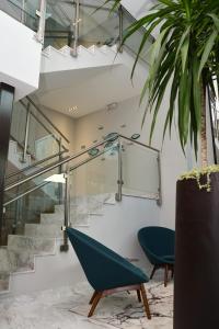 a staircase in a building with a green chair at El San Geronimo in San Juan