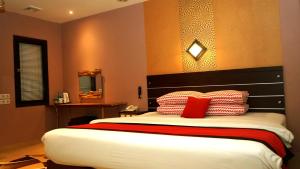 Rúm í herbergi á Citi M Hotel Gambir
