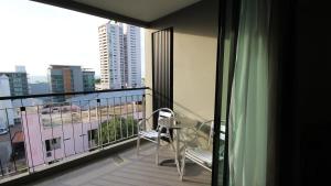 a balcony with a table and chairs on a building at Season Five Hotel "SHA Certified" in Pattaya