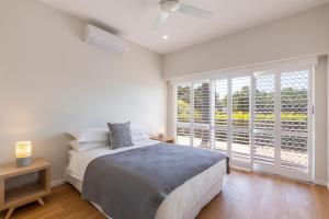 a bedroom with a bed and a large window at Location, location, Sunshine Beach in Sunshine Beach +9 photos