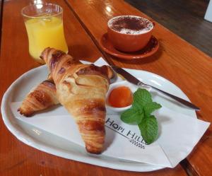 a plate of food with croissants and a glass of orange juice at The Yurts at Margo's Garden, Kiroro in Shiribeshi +20 photos