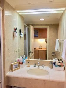 a bathroom with a sink and a large mirror at 台中晶華居 Fine House Taichung in Taichung