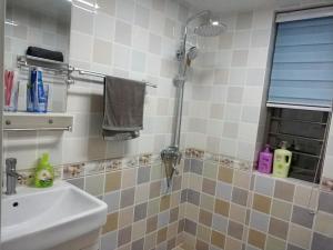 a bathroom with a sink and a shower at Henan Luoyang·Wangfujing Department Store· Locals Apartment 00129770 in Luoyang