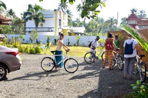 een groep mensen die met hun fietsen rondlopen bij Marari Green Villas in Mararikulam