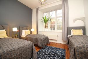 A bed or beds in a room at Tallinn City Apartments - Old Town