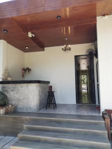 a lobby with stairs and a wooden ceiling at Samed Your House in Ko Samed