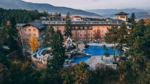 a resort with a pool in front of a building at Spa Hotel Dvoretsa in Velingrad