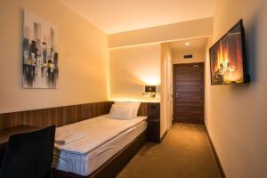 Rúm í herbergi á Hotel Spa Grad