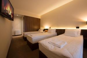 Rúm í herbergi á Hotel Spa Grad