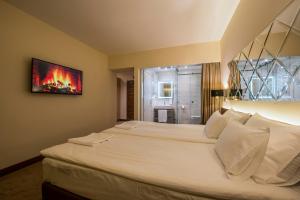 Rúm í herbergi á Hotel Spa Grad