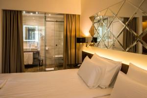Rúm í herbergi á Hotel Spa Grad