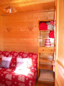 une petite chambre avec un canapé rouge dans une cabine dans l'établissement MONT BLANC SOLEIL E-2, à Manigod