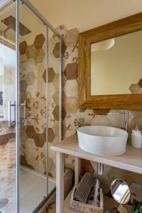 a bathroom with a sink and a glass shower at Perle d'Ambra in Lucca