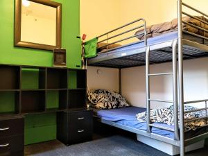 a room with bunk beds and a mirror at Landing Pads Brunswick in Melbourne