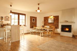 a living room with a table and a fireplace at U Floderů in Bavory