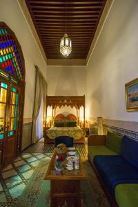 A bed or beds in a room at Riad Myra