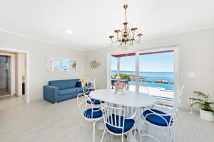 a living room with a table and chairs and a view of the ocean at A brand NEW VILLA - Infinity in Podstrana
