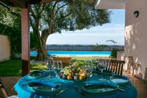 stół z talerzem owoców i kieliszkami do wina w obiekcie Villa del mar w mieście Quartu SantʼElena