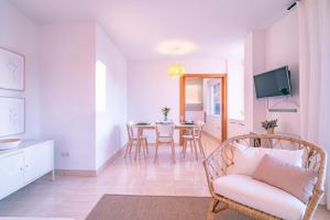 a living room with a chair and a table at Livemálaga Terrace Deluxe in Málaga