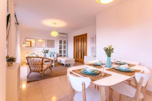 a dining room and living room with a table and chairs at Livemálaga Terrace Deluxe in Málaga