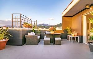 a patio with wicker chairs and tables on a building at Livemálaga Terrace Deluxe in Málaga
