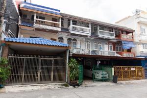 a building with a gate in front of it at Mango 10 House in Bangkok