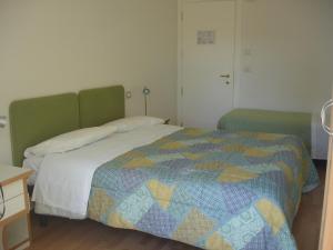 A bed or beds in a room at Petit Hotel