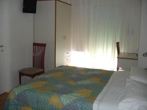 A bed or beds in a room at Petit Hotel