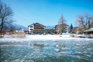 a frozen river in front of some buildings at Hotel Terrassenhof in Bad Wiessee