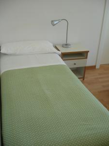 A bed or beds in a room at Petit Hotel