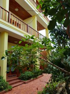 a building with stairs and plants in front of it at Free Beach Resort in Phú Quốc