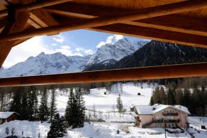 a view of a snowy mountain from a cabin at BAD MOOS Dependance "Mühlenhof" in Sesto