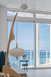 a living room with a table and a chandelier at Les Bords De Mer in Marseille