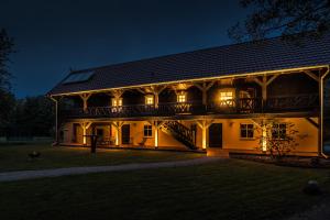 a large house at night with its lights on at Adelinenhof - Ferienapartments, Fasten, Wellness & Gesundheit in Burg