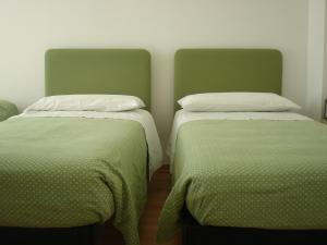 A bed or beds in a room at Petit Hotel