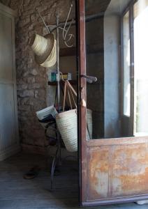 a door in a room with a chair and a basket at Domaine Les Martins - Gordes in Gordes +34 photos
