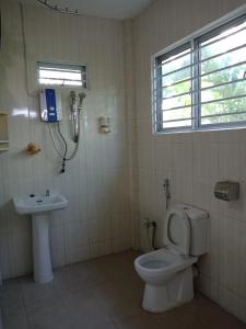 a bathroom with a toilet and a sink at Jazepuri - Jaze 2 in Kuching