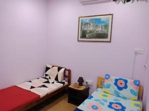 a bedroom with a bed and a couch and a picture at Jazepuri - Jaze 2 in Kuching
