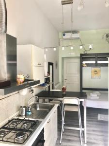 a kitchen with a sink and a stove top oven at Luxy Vatican Apartment in Rome