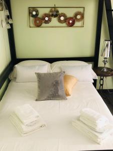 a white bed with white sheets and pillows on it at Luxy Vatican Apartment in Rome