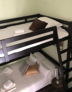 a couple of bunk beds with white sheets and pillows at Luxy Vatican Apartment in Rome