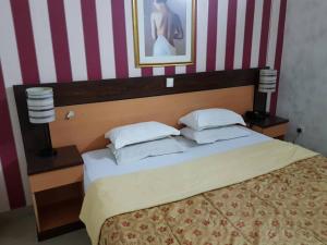 Rúm í herbergi á Citilodge Hotel