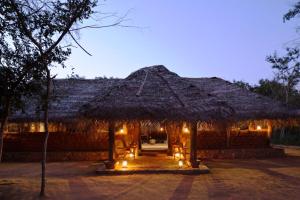 a hut with lights in front of it at night at Greenwood Udawalawa Safari Resort in Udawalawe